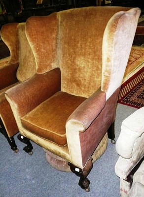 Lot 520 - * A wing back chair on claw and ball feet