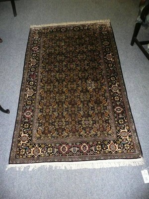 Lot 528 - Kashmir silk rug North West India, the jet black field of Herati design enclosed by samovar borders