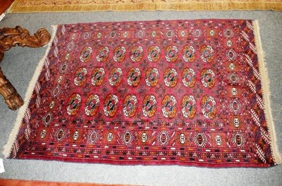 Lot 552 - Tekke rug West Turkestan, the brick red field with rows of quartered guls