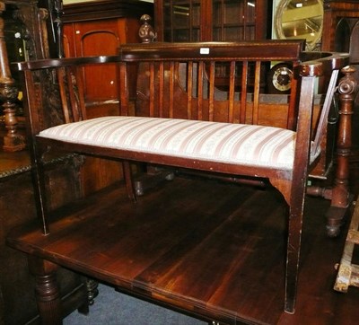 Lot 580 - An Edwardian mahogany slat-framed small settee