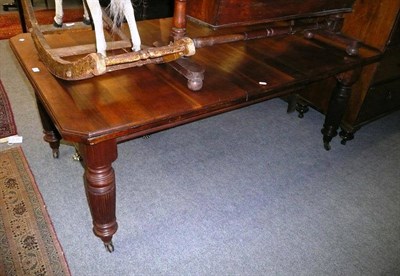 Lot 583 - Victorian walnut wind out dining table, including one leaf and winder