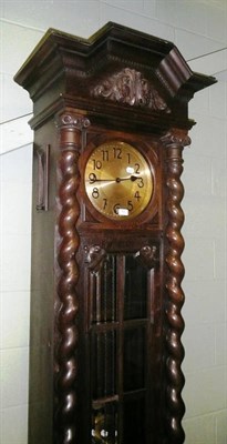 Lot 597 - An oak longcase clock