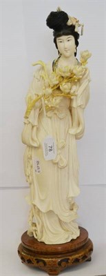 Lot 78 - A Chinese Carved Elephant Ivory Figure of a Maiden, 20th century, standing holding a sprig of...