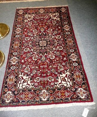 Lot 613 - Indian rug, The ox blood field with central medallion enclosed by cartouche borders