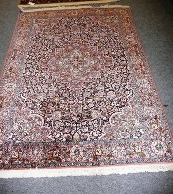 Lot 614 - Kashmir silk rug North West India, the midnight blue field centred by a salmon pink and ivory...