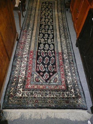 Lot 648 - Narrow North West Persian runner, the midnight blue field with rows of boteh