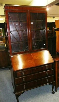 Lot 656 - * A 1920s mahogany bureau bookcase