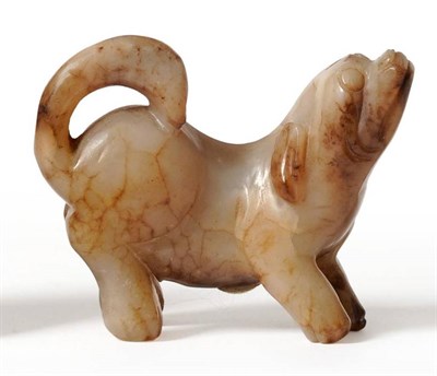 Lot 94 - A Chinese Carved Jade Figure of a Dog, in Ming style, standing, its head raised, 6.5cm high
