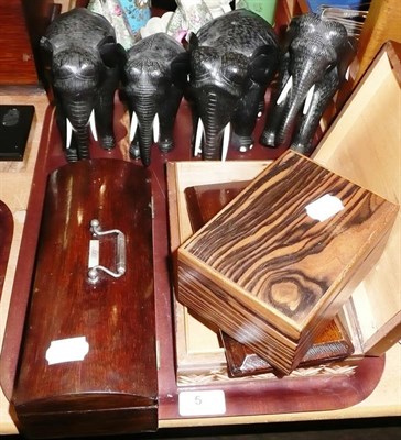 Lot 5 - Four ebony elephants, a rosewood box, two more boxes and tie press