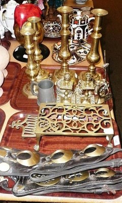 Lot 23 - Three pairs of brass candlesticks, two horse brasses etc (on two trays)