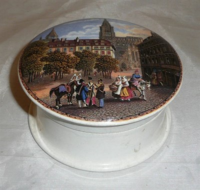 Lot 68 - A mid 19th century pot lid depicting a view of Strasbourg, complete with base