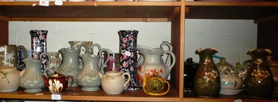 Lot 71 - Two shelves of decorative ceramics including a graduated set of three relief moulded jugs, two...