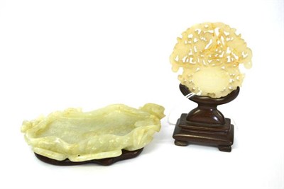 Lot 108 - A Chinese Jade Plaque, carved and pierced with a bird amongst foliage in a jardinière, 5.5cm high