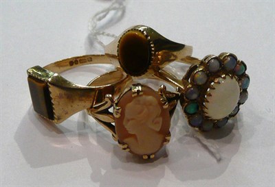 Lot 108 - Four 9ct gold dress rings, set with opals, tiger's eye and a cameo