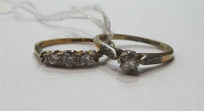 Lot 114 - A diamond set ring (two stones missing) and a diamond solitaire ring