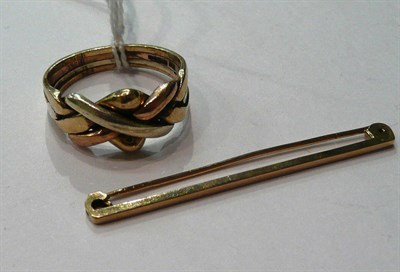 Lot 119 - A three colour puzzle ring and a tie pin