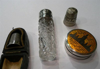 Lot 139 - One silver thimble, one plated thimble, silver enamel pill box and a silver and cut glass scent...