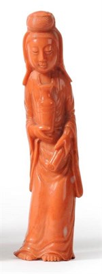 Lot 113 - A Chinese Coral Figure of Guanyin, 20th century, standing wearing flowing robes holding a vase...