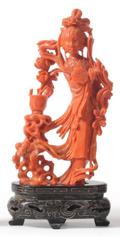 Lot 114 - A Chinese Coral Figure of a Maiden, 20th century, standing in flowing robes holding a fan, a...