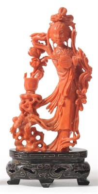 Lot 114 - A Chinese Coral Figure of a Maiden, 20th century, standing in flowing robes holding a fan, a...