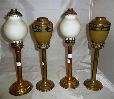 Lot 166 - Two pairs of brass sprung candlesticks with pierced castellated rims and glass shades with...