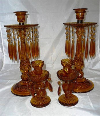 Lot 203 - A pair of large amber cut glass candle lustres and drops and a similar smaller pair (4)