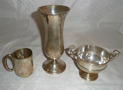 Lot 221 - An Edwardian silver pedestal vase, London 1908; a silver christening mug and a small two...