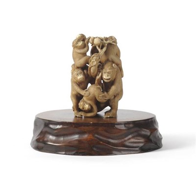 Lot 129 - A Japanese Ivory Okimono, Meiji period, as a group of tumbling monkeys holding fruiting...