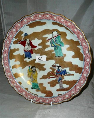 Lot 324 - A Japanese Arita dish decorated with four figures