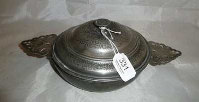 Lot 331 - An 18th century pewter ecuelle, with two pierced flat leaf shape side handles, the domed...