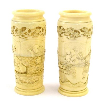 Lot 133 - A Pair of Japanese Ivory Sectional Vases, Meiji period, carved with boys playing in a garden within