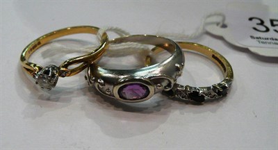 Lot 359 - A white gold and amethyst ring, an 18ct gold and diamond solitaire ring and a 9ct gold sapphire and