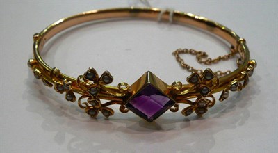 Lot 364 - An amethyst and seed pearl gold bangle