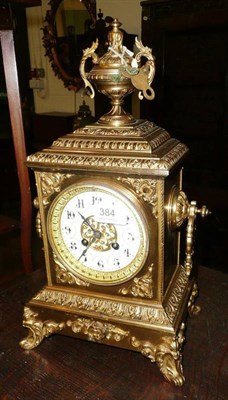 Lot 384 - An ornate brass mantel clock