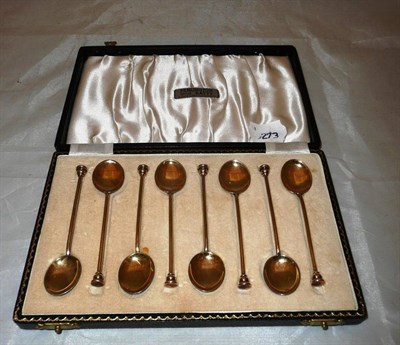 Lot 406 - A cased set of silver gilt enamel coffee spoons