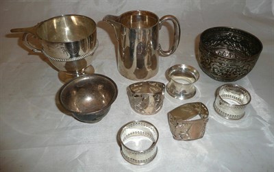 Lot 419 - A silver cup, silver jug, five silver napkin rings, two silver bowls etc