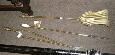 Lot 508 - Set of three brass fire irons and poker rest