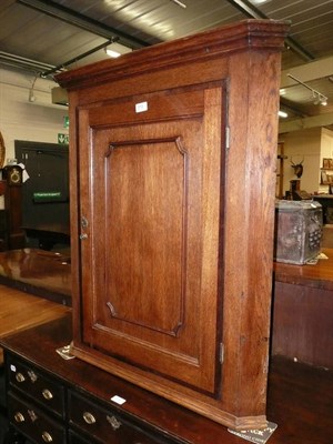 Lot 513 - A Georgian oak straight fronted corner cabinet