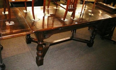 Lot 539 - A reproduction oak draw leaf refectory table