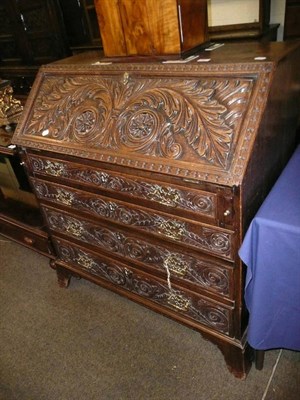 Lot 542 - Carved oak bureau