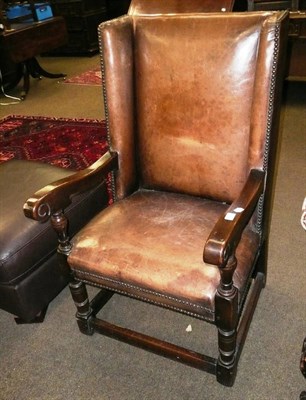 Lot 546 - An 18th century style leather upholstered oak open armchair