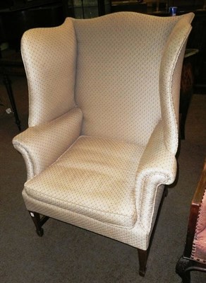 Lot 570 - A Georgian style wing armchair