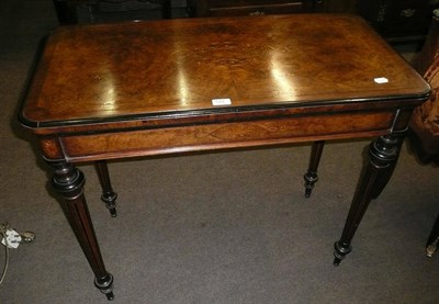 Lot 572 - Victorian inlaid walnut swivel top card table