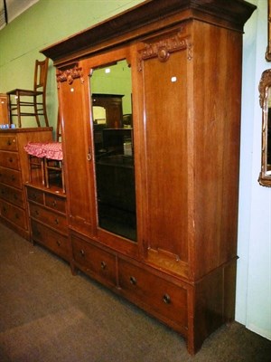 Lot 603 - An Edwardian carved oak wardrobe, a matching chest of drawers and three side chairs