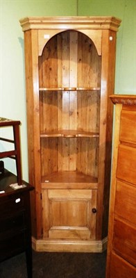 Lot 605 - A pine floor standing corner cupboard