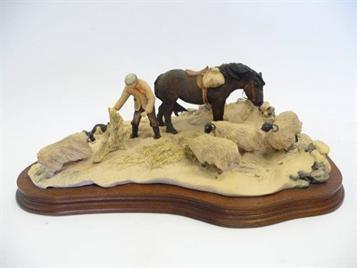 Lot 1036 - Border Fine Arts 'Winter Feeding' shepherd with pony and sheep in snow, model No. JH10 by Judy...