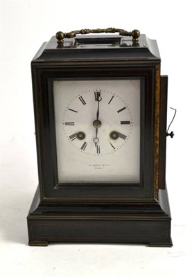 Lot 4 - An ebonised mantel clock retailed by J Sewell