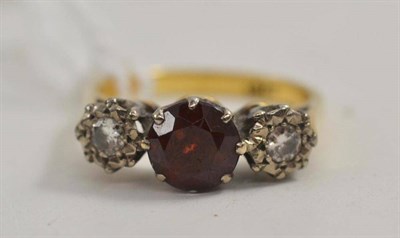 Lot 89 - A garnet and diamond three stone ring