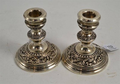 Lot 102 - Pair of silver embossed dwarf candlesticks, inscribed and dated Nov. '66