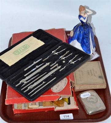 Lot 114 - A Doulton figure, HN3136, Laura, a silver cigarette case and a collection of technical drawing...